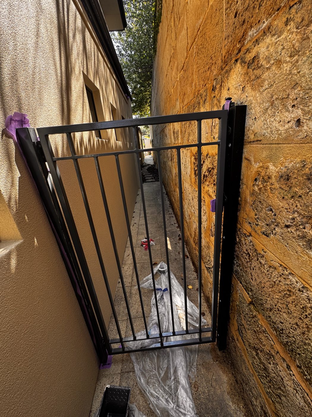Side gate fitted down a narrow side path