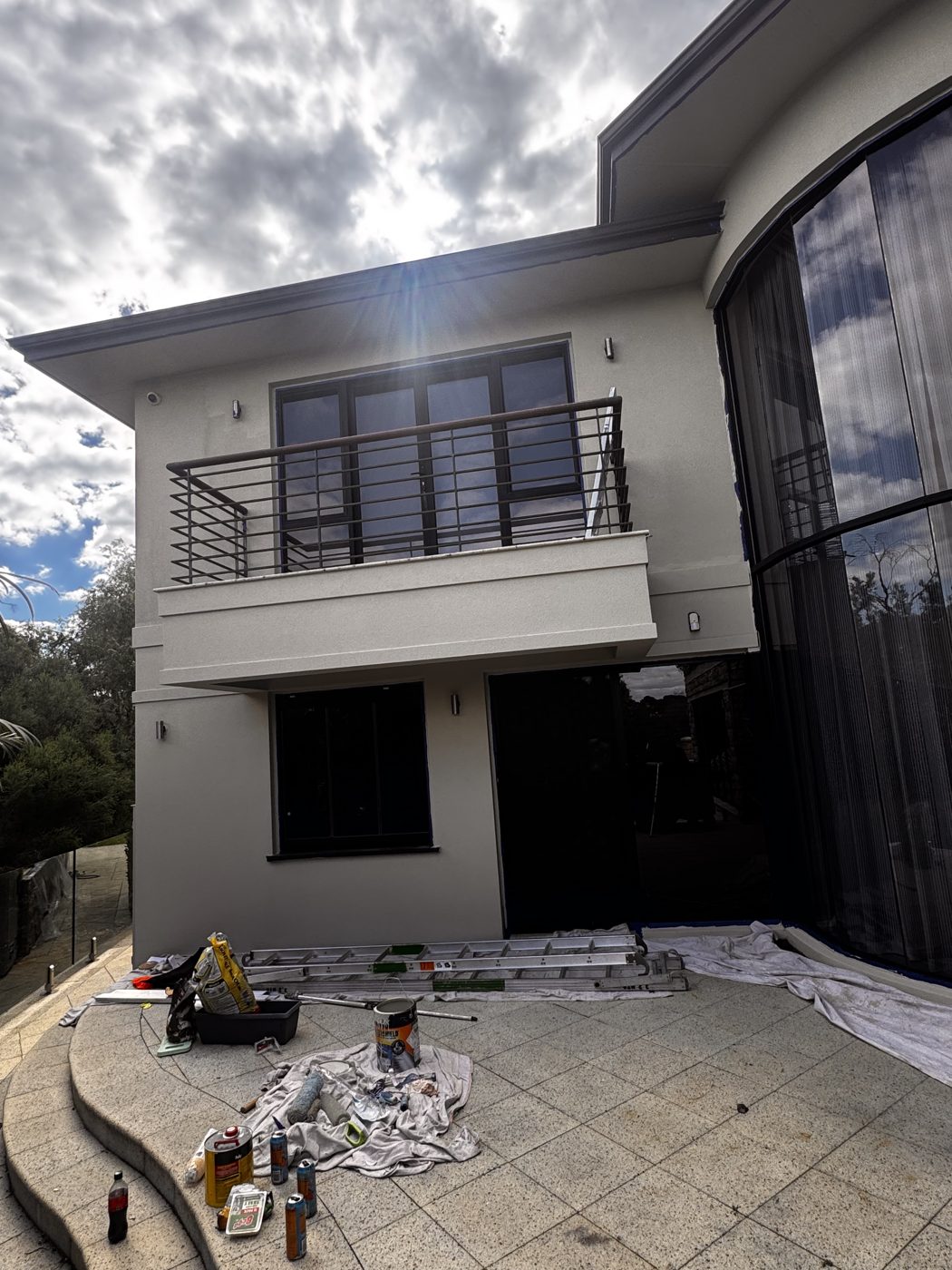 Two-storey rendered home during an exterior repaint
